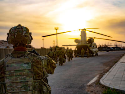 Soldiers board a CH-47 Chinook helicopter as they depart from al-Qaim base, Iraq, on March 9, 2020.