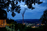 A backyard overlooks the valley to the GenOn Cheswick Power Station, which still burns coal to produce 637 megawatts of electricity for the region on June 7, 2021, in Cheswick, Pennsylvania.