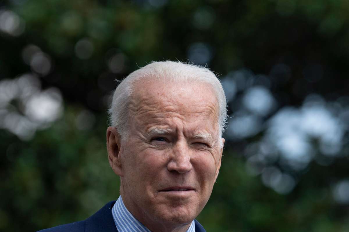 Joseph Robinette Biden squints into the sun, having forgotten his signature aviator sunglasses