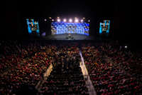 Donald Trump speaks to his audience, in an indoor venue