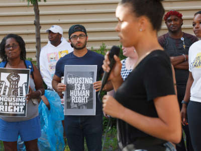 Housing advocates hold placards advocating for affordable housing while activist and former Democratic candidate for Ohios third congressional district Morgan Harper speaks about the housing crisis. The protest was in reaction to the upcoming expiration of the eviction moratorium.