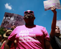 A protester wears an "I stand with Planned Parenthood" shirt at a demonstration against recently passed abortion ban bills at the Georgia state capitol building on May 21, 2019, in Atlanta, Georgia.