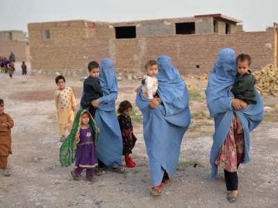 Members of an internally displaced Afghan family who left their home during the ongoing conflict between Taliban and Afghan security forces arrive from Qala i Naw to the Injil District of Herat on July 8, 2021.