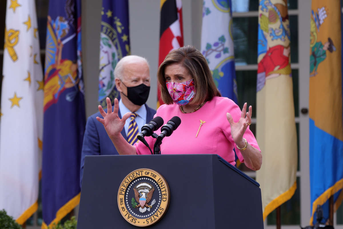Speaker of the House Rep. Nancy Pelosi speaks as President Joe Biden listens during an event on the American Rescue Plan in the Rose Garden of the White House on March 12, 2021, in Washington, D.C.