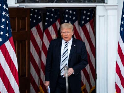 Donald Trump is surrounded by U.S. flags