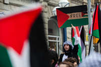 A person holds up a sign reading "free Palestine" during a protest