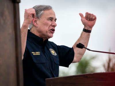 Greg Abbott pumps his arms at a rally