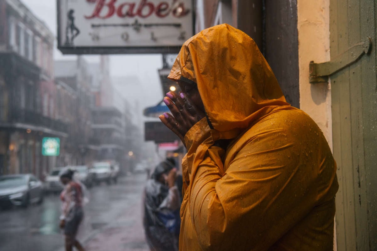 Kandaysha Harris wipes her face before continuing traveling through the storm of Hurricane Ida on August 29, 2021 in New Orleans, Louisiana.