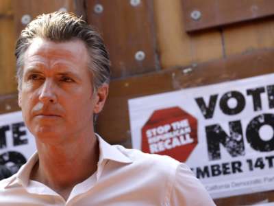 California Gov. Gavin Newsom meets with Latino leaders and volunteers working to call voters and urge them to vote against the recall at Hecho en Mexico restaurant in East Los Angeles on August 14, 2021.