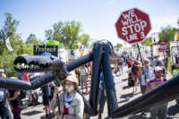 A makeshift "black snake" resembling a pipeline was carried as 2,000 Indigenous leaders and water protectors from around the country marched along Highway 9 in Clearwater County, Minnesota, on June 7, 2021, to protest the construction of Enbridge Line 3.