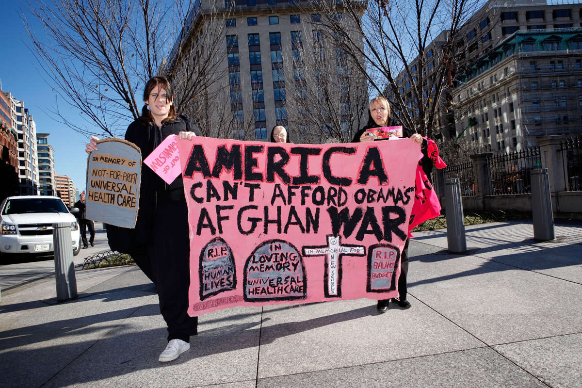 CODEPINK Members Midge Potts and Medea Benjamin march during a protest against escalation of the war in Afghanistan in front of the White House on December 1, 2009, in Washington, D.C.