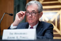 Jerome Powell looks over his glases