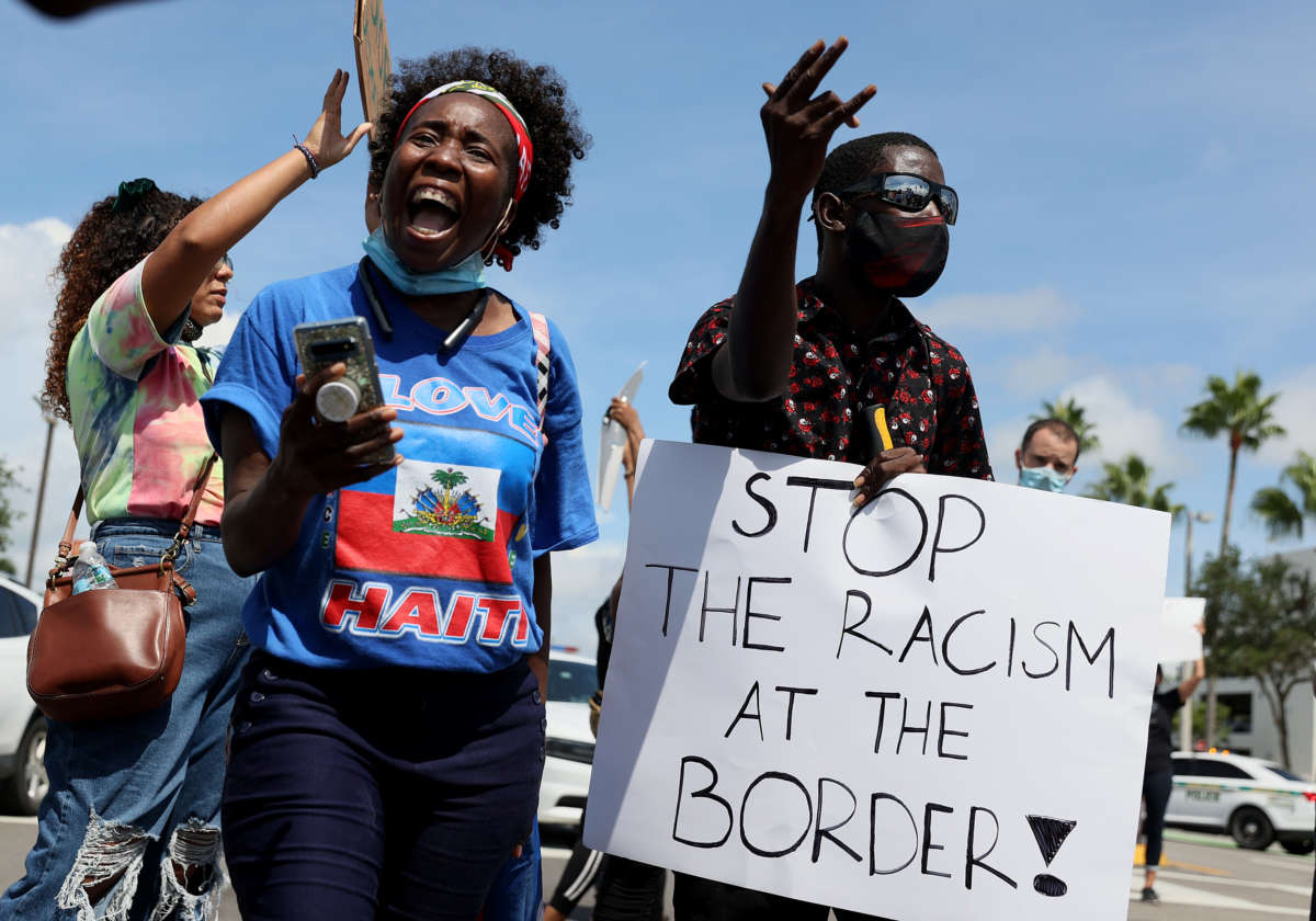 Protesters join together in front of a USCIS Building to denounce the expulsion of Haitian refugees from Del Rio, Texas, on September 22, 2021 in Miami, Florida.