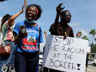 Protesters join together in front of a USCIS Building to denounce the expulsion of Haitian refugees from Del Rio, Texas, on September 22, 2021 in Miami, Florida.