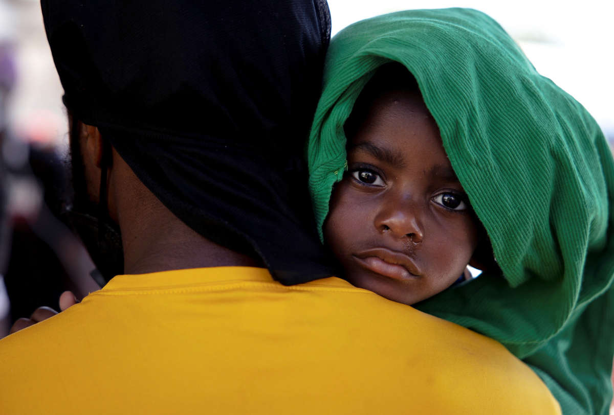 A father holds his baby