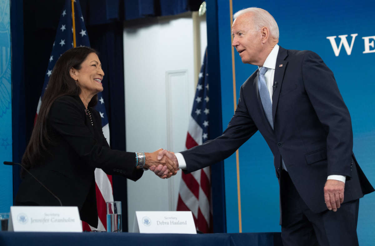 President Joe Biden shakes hands with Secretary of the Interior Deb Haaland as he arrives for a briefing on wildfires with cabinet members, government officials, as well as governors of several western states, in the Eisenhower Executive Office Building in Washington, D.C., on June 30, 2021.