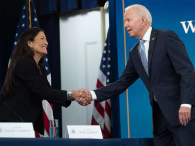 President Joe Biden shakes hands with Secretary of the Interior Deb Haaland as he arrives for a briefing on wildfires with cabinet members, government officials, as well as governors of several western states, in the Eisenhower Executive Office Building in Washington, D.C., on June 30, 2021.