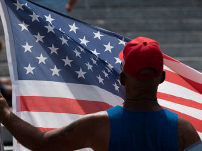 A man displays his U.S. flag during the Kentucky Freedom Rally at the capitol building on August 28, 2021 in Frankfort, Kentucky. Demonstrators gathered to speak out against a litany of issues, including Kentucky Gov. Andy Beshear's management of the coronavirus pandemic, abortion laws and the teaching of critical race theory.