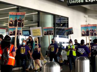 Airport employees and community allies protest a proposed expansion of Los Angeles International Airport on September 14, 2021.