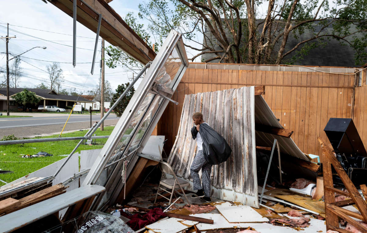 Chelsea Jenkins salvages whatever she can from the Be Love hair salon, owned by Jenkins's mother, which was destroyed by Hurricane Ida on August 30, 2021, in LaPlace, Louisiana.