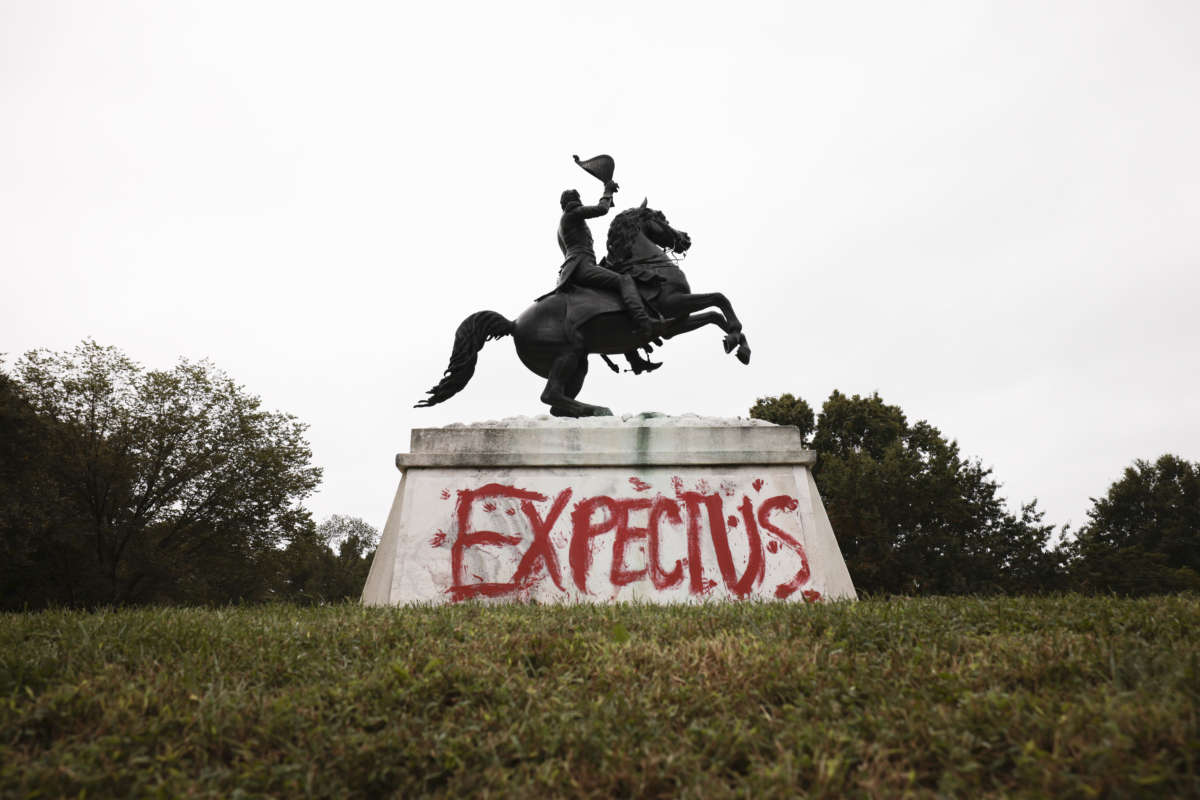 The words "Expect Us" are seen painted at the base of a statue of U.S. President Andrew Jackson during a climate march in honor of Indigenous Peoples’ Day at in front of the White House on October 11, 2021 in Washington, D.C.