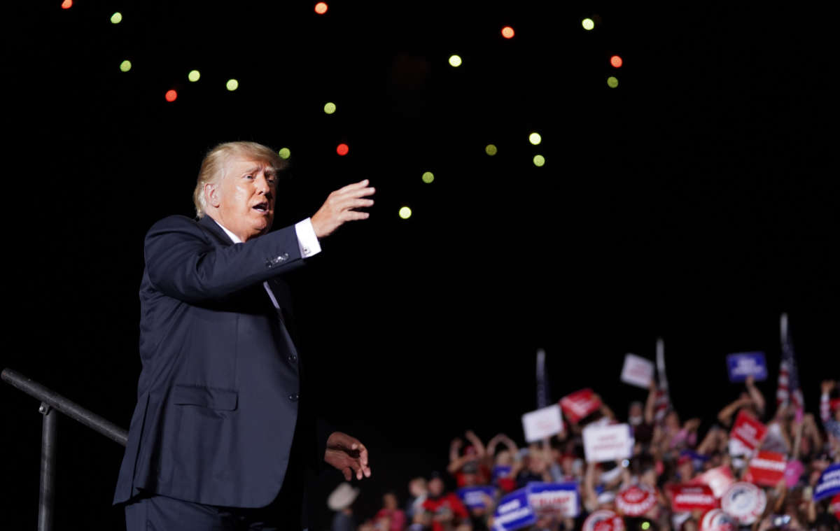 Former President Donald Trump waves to the crowd at the end of a rally on September 25, 2021, in Perry, Georgia.