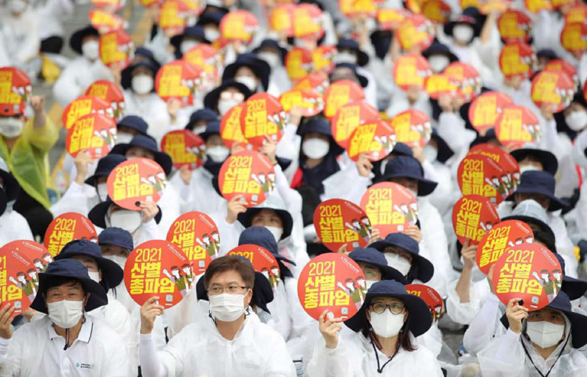 Members of the Korean Health and Medical Workers Union, a KCTU affiliate, gather in front of the Ministry of Health and Welfare in Sejong City, South Korea, on June 23, 2021, to demand improved working conditions and expand public health care.
