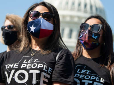 Texas State Representatives Mary Ann Perez, center, and Christina Morales, right, attend a news conference with members of the Texas House Democratic Caucus outside the U.S. Capitol on August 6, 2021.