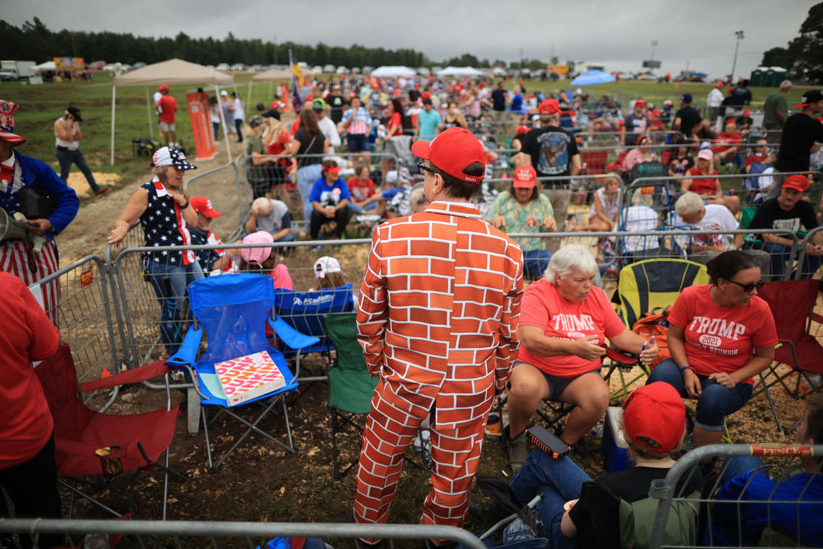 Supporters of former President Donald Trump line up to attend a "Save America" rally at York Family Farms on August 21, 2021, in Cullman, Alabama.