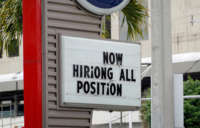 A Now Hiring sign is pictured outside of a business on October 8, 2021, in Miami, Florida.