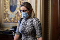 Sen. Kyrsten Sinema departs from a caucus meeting with Democratic Senators at the U.S. Capitol Building on October 6, 2021, in Washington, D.C.