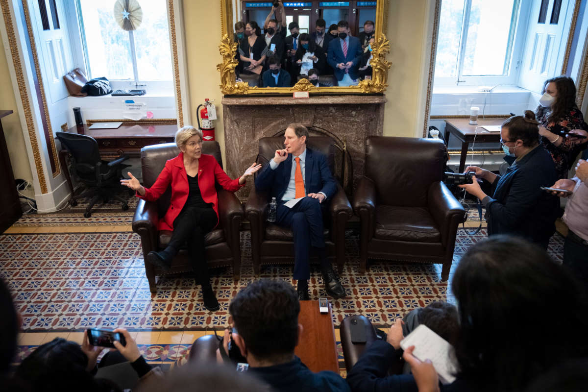 Sens. Elizabeth Warren and Ron Wyden speak to reporters about a corporate minimum tax plan at the U.S. Capitol on October 26, 2021, in Washington, D.C.