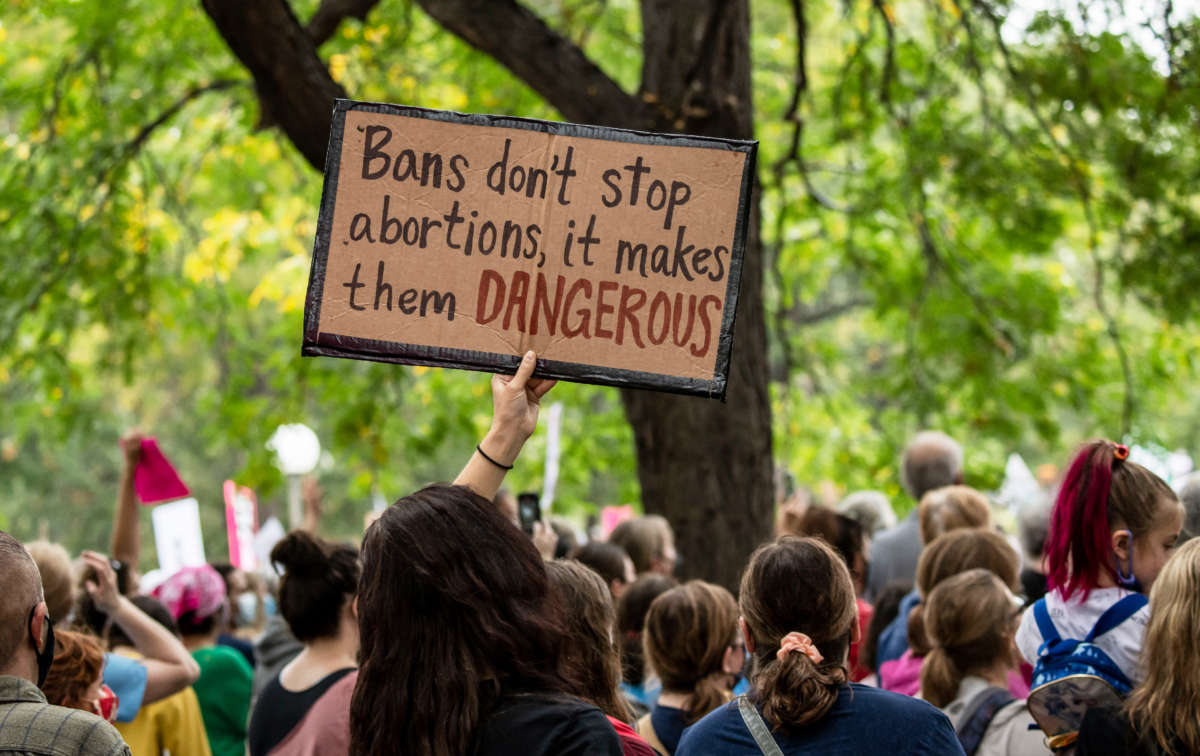 A sign reads "Bans don't stop abortions, they make them dangerous" at a march for reproductive freedom on October 2, 2021, in Minneapolis, Minnesota.