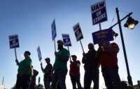 Workers picket outside of John Deere Harvester Works facility on October 14, 2021, in East Moline, Illinois.