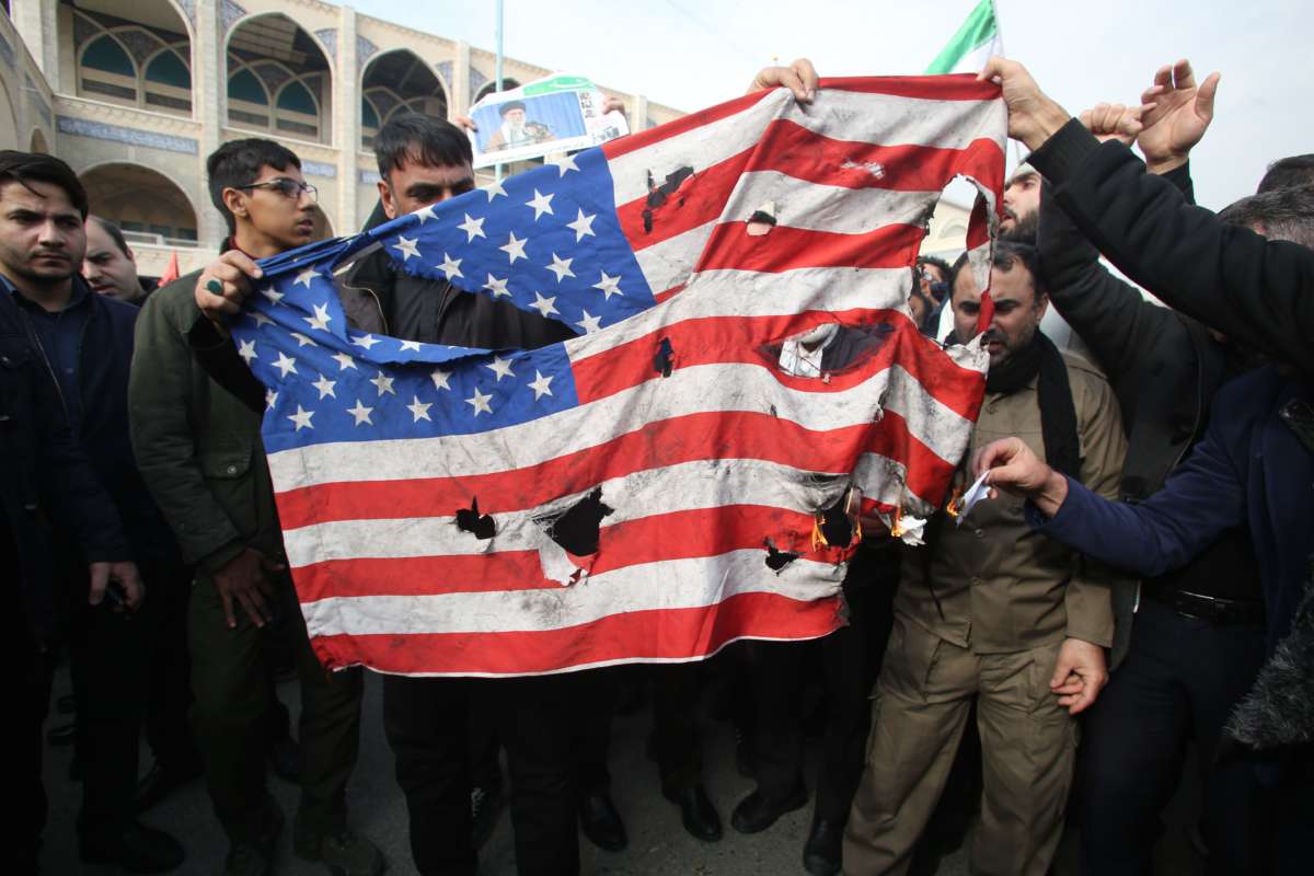 Iranians burn a U.S. flag during a demonstration against American "crimes" in Tehran on January 3, 2020, following the assassination of Iranian Revolutionary Guards Major General Qassim Suleimani in a U.S. strike on his convoy at Baghdad international airport.