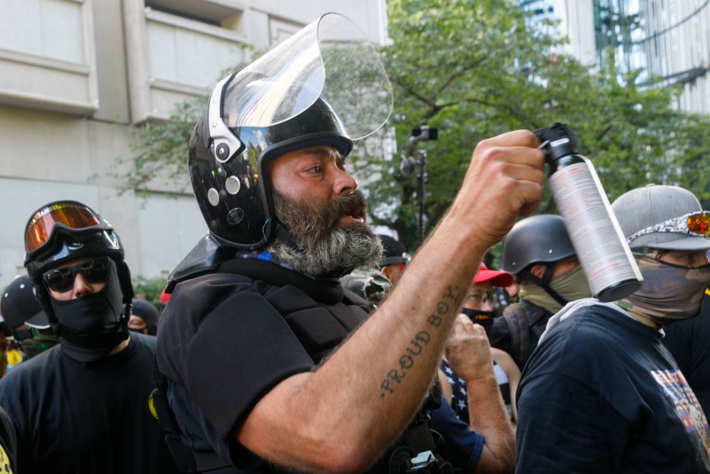 Alan Swinney, a "Proud Boy" member, pepper-sprays counter-demonstrators as right-wing demonstrators, many armed, clash violently with Black Lives Matter and antifascist counter-demonstrators, in Portland, Oregon, on August 22, 2020.