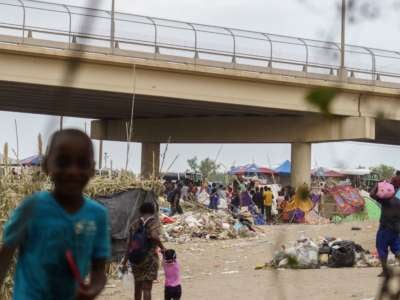 Haitian migrants are pictured in a makeshift encampment where more than 12,000 people hoping to enter the United States await under the international bridge in Del Rio, Texas on September 21, 2021.