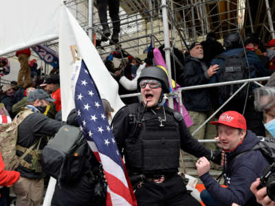 A man calls on people to raid the building as Trump supporters clash with police and security forces as they try to storm the U.S. Capitol in Washington, D.C., on January 6, 2021.