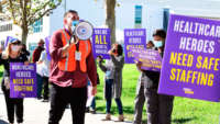 Workers protest Kaiser Permanente's attempt to replace workers who have good environmental services housekeeping jobs with robots, at Baldwin Park Medical Center outside the facility on November 10, 2020, in Baldwin Park, California.
