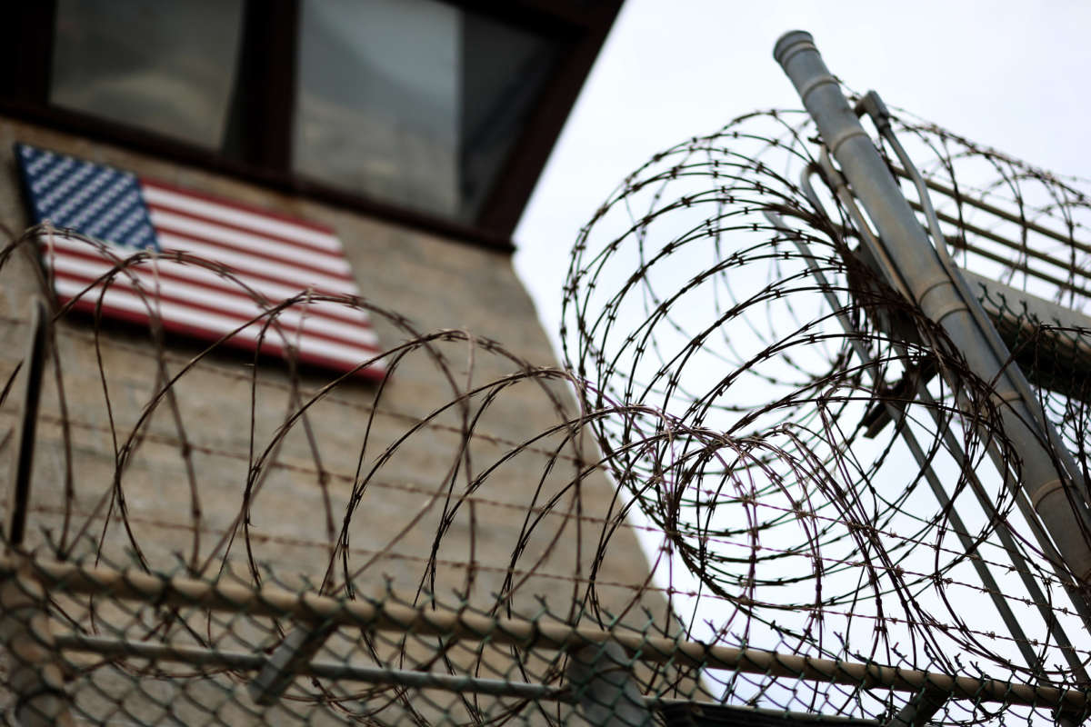 Razor wire tops a fence near the guard tower at the entrance to Camp V and VI at the U.S. military prison for "enemy combatants" on June 25, 2013, in Guantánamo Bay, Cuba.