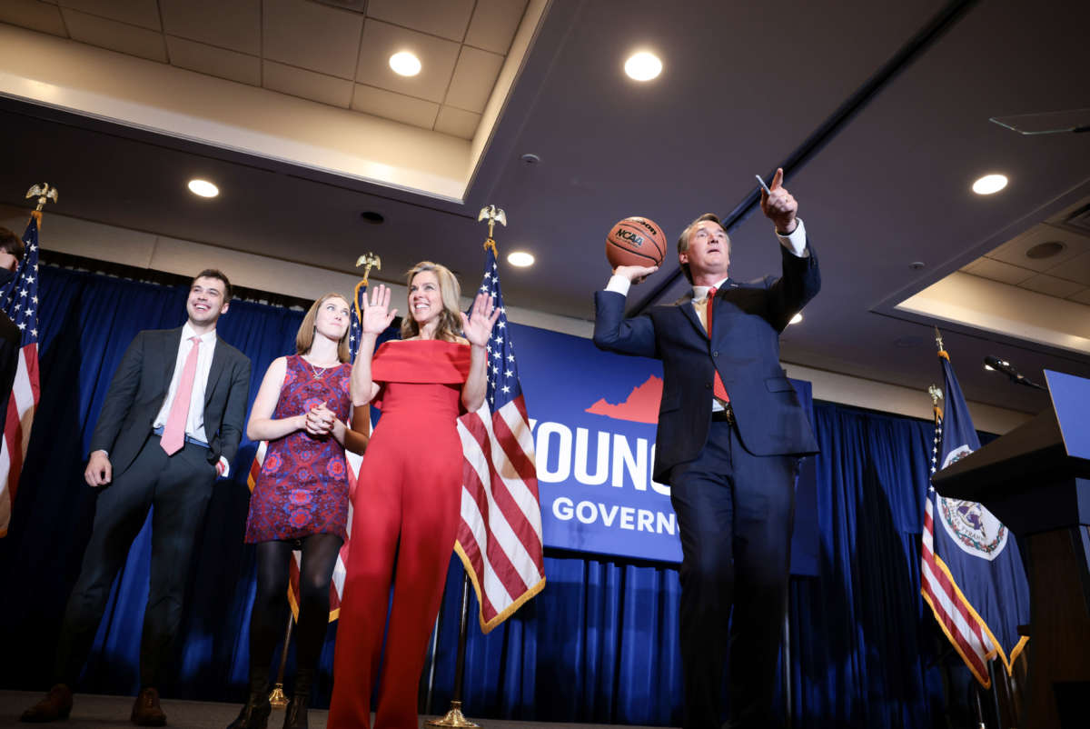 Virginia Republican gubernatorial candidate Glenn Youngkin passes an autographed basketball into the crowd with his family at his election night rally at the Westfields Marriott Washington Dulles on November 2, 2021, in Chantilly, Virginia.