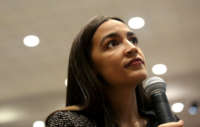 Rep. Alexandria Ocasio-Cortez speaks with members of the media before a Green New Deal For Public Housing Town Hall on December 14, 2019, in the Queens borough of New York City.