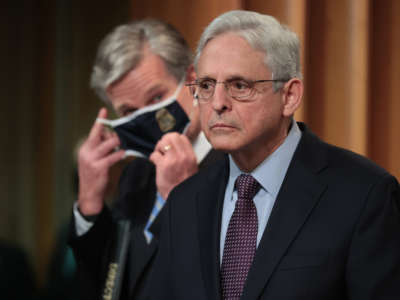 Attorney General Merrick Garland, right, and FBI Director Christopher Wray hold a press conference at the Robert F. Kennedy Main Justice Building on November 8, 2021, in Washington, D.C.