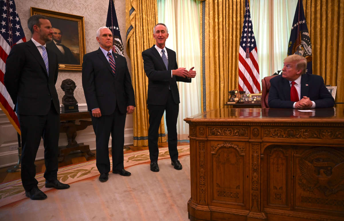 President Donald Trump, right, Vice President Mike Pence and U.S. International Development Finance Corporation CEO Adam Boehler, left, listen to Daniel O'Day, CEO of Gillead Sciences Inc., as he speaks in the Oval Office of the White House on May 1, 2020, in Washington, D.C.