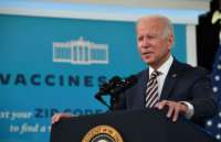 President Joe Biden speaks at podium on vaccines at South Court Auditorium of White House