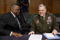 Defense Secretary Lloyd Austin, left, laughs with Chairman of the Joint Chiefs of Staff Gen. Mark Milley before their testimony at a Senate Committee on Appropriations hearing on the 2022 budget for the Defense Department