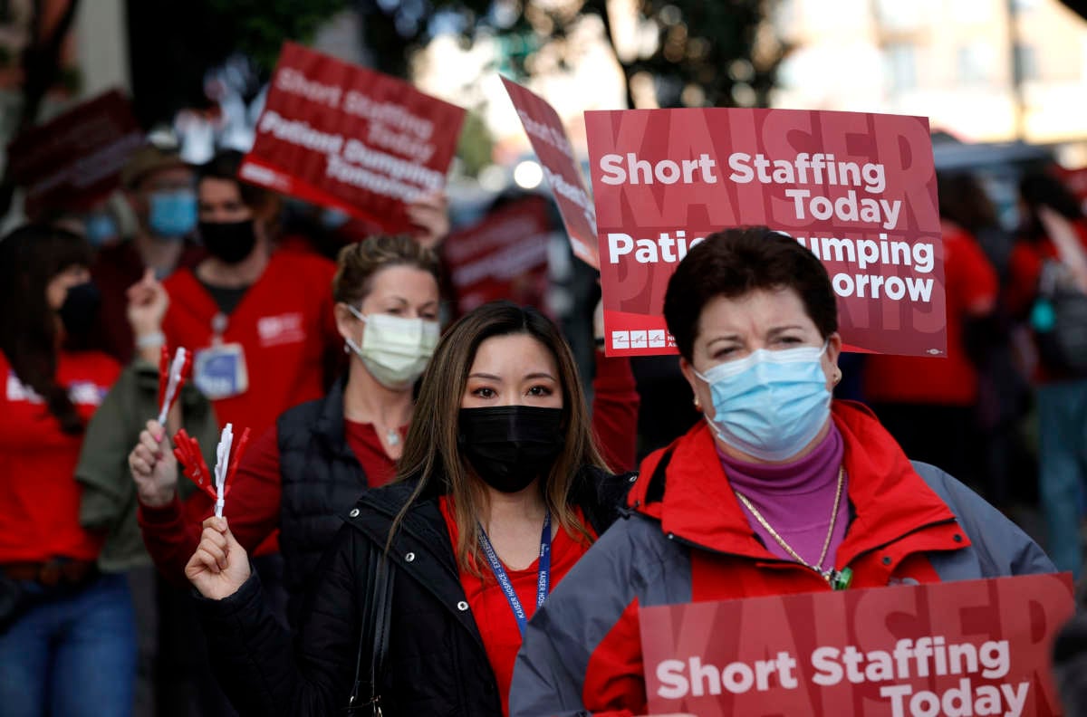 Kaiser Permanente nurses and workers hold signs as they stage an informational picket outside of the Kaiser Permanente San Francisco Medical Center on November 10, 2021 in San Francisco, California.