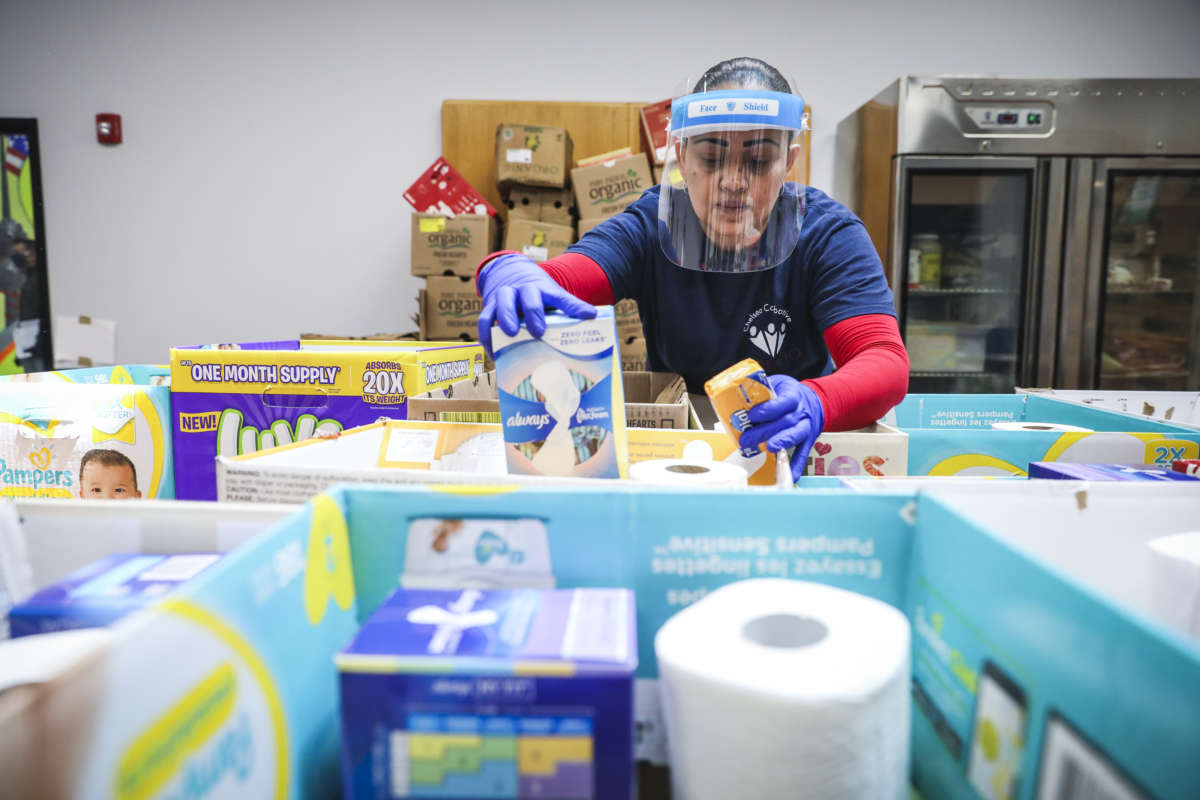 Chelsea Collaborative volunteer Jessica Armijo sorts through aid to be distributed, including food, diapers and baby formula in Chelsea, Massachusetts, on May 2, 2020.