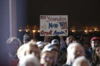 Supporters hold up homemade signs as Republican gubernatorial candidate Glenn Youngkin speaks at a campaign rally on October 29, 2021, in Warrenton, Virginia.