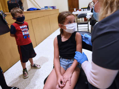 A girl recieves the covid vaccine